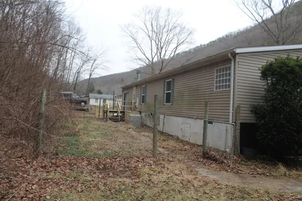 an empty room with wooden floor and a window