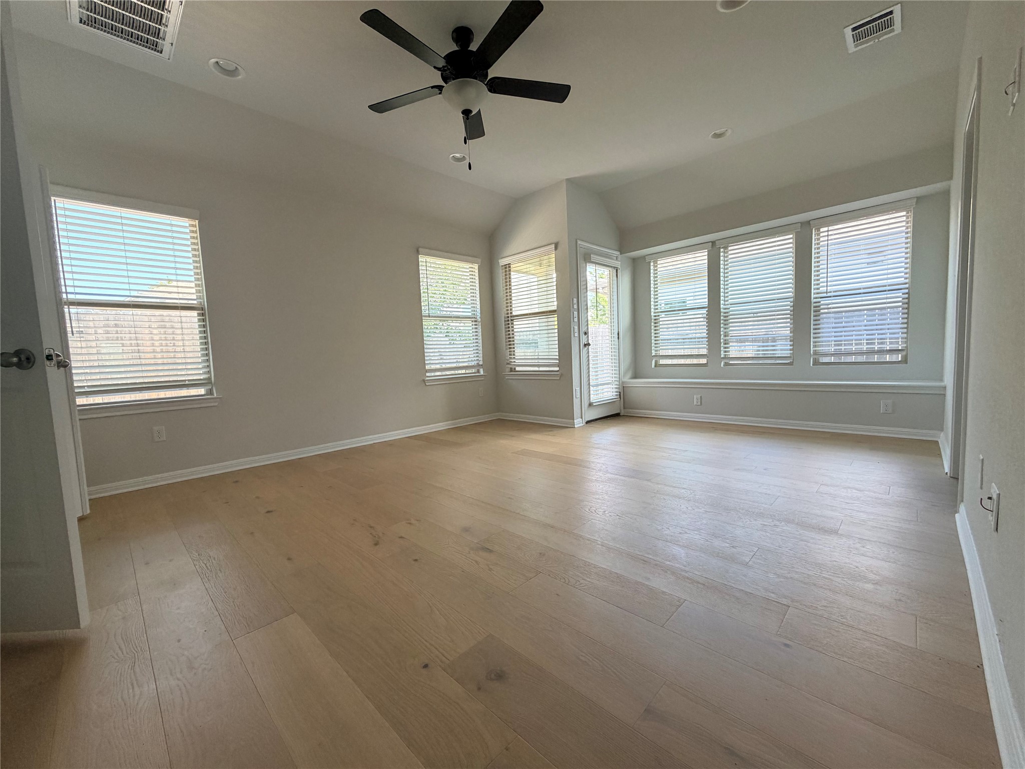2813 Hopi Path, Unit 11 Leander, TX 78641 - Photo 15 of 17 Spare room featuring ceiling fan, light wood-style flooring, recessed lighting, and lofted ceiling