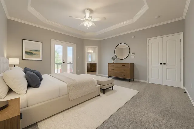 a spacious bedroom with a bed and a chandelier