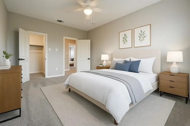 a bedroom with a bed windows and a chandelier