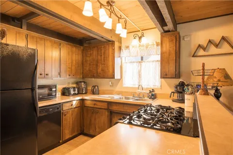 a kitchen with a sink stove and refrigerator