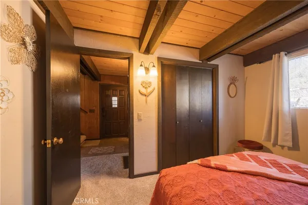 a bedroom with a bed and a mirror