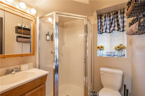 a bathroom with a sink a toilet and shower curtain