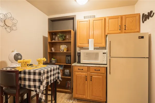 a kitchen with a refrigerator and table