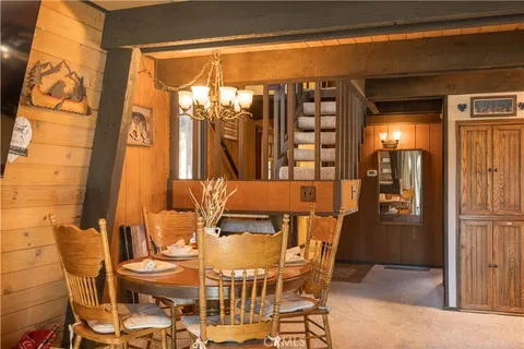a view of a dining room with furniture and chandelier