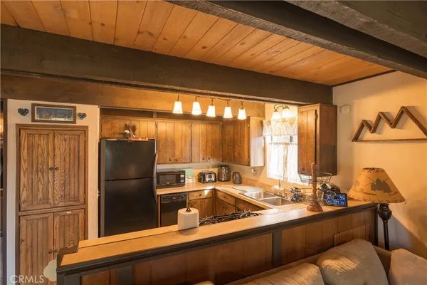 a kitchen with a refrigerator and sink