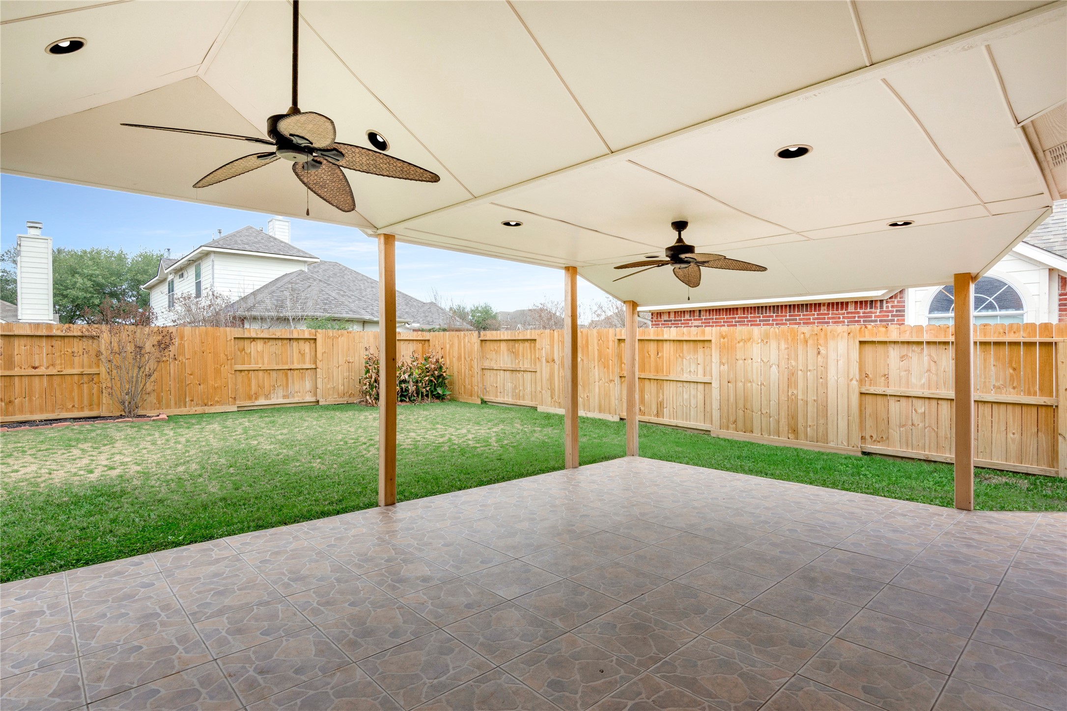 8106 Cove Timbers Lane Tomball, TX 77375 - Photo 21 of 27 Large covered patio is ready for your next family gathering with two ceiling fans and recessed lighting.