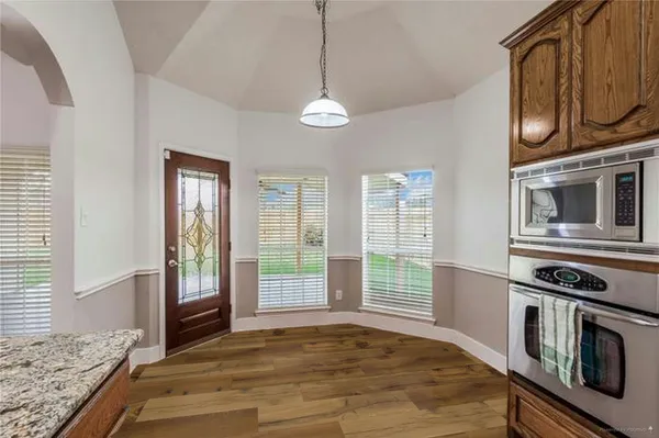 a view of an empty room with window and cabinet
