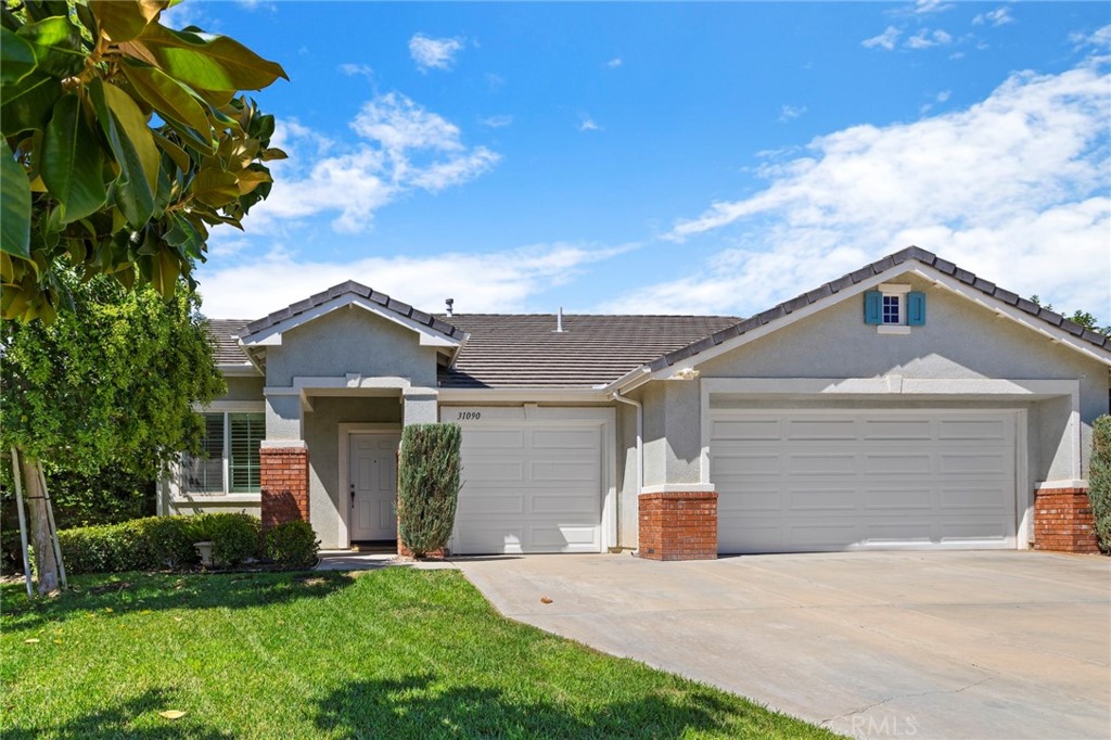 31090 Euclid Loop Winchester, CA 92596 - Photo 1 of 1 a front view of a house with a yard and garage