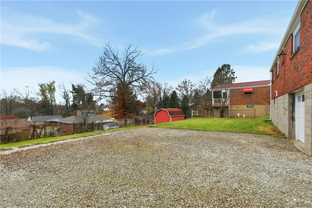 a view of a backyard with large trees