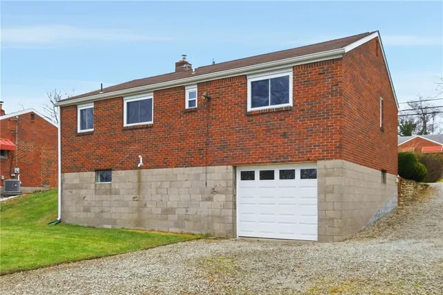 a sign that is sitting in front of a house