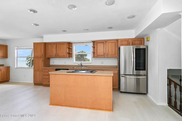 a kitchen with stainless steel appliances granite countertop a refrigerator stove and a sink