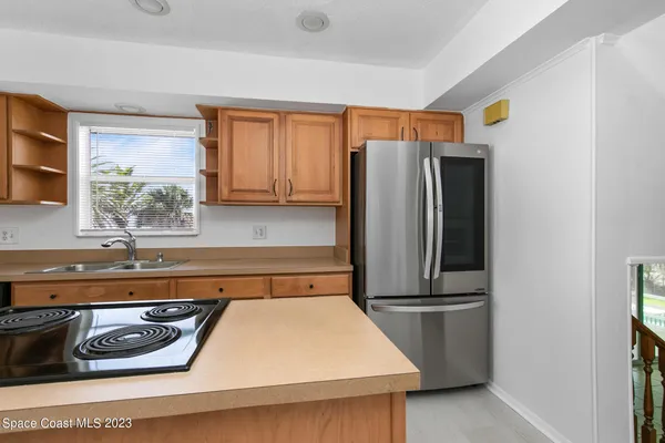 a kitchen with stainless steel appliances granite countertop a refrigerator and a sink
