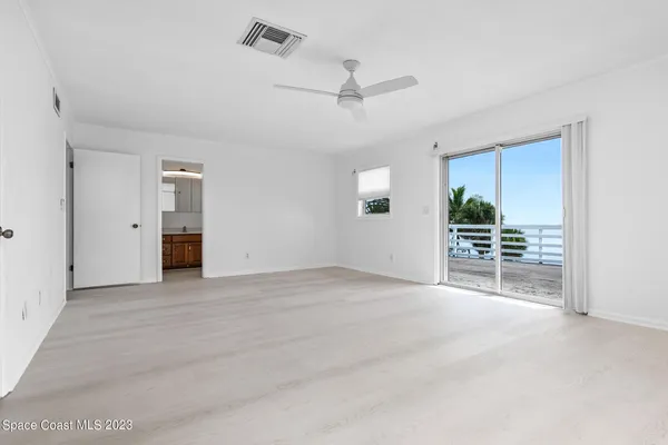 a view of a house with wooden fence