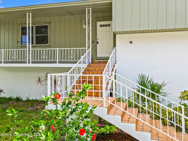 a view of front door and potted plants