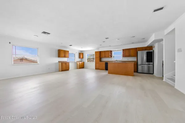 a view of a livingroom with furniture and an empty room