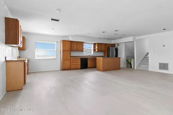 a view of a kitchen with a sink and cabinets