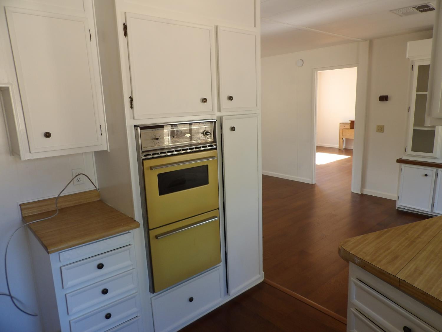 44001 Dunlap Road Miramonte, CA 93641 - Photo 43 of 91 a kitchen with cabinets appliances and a wooden floor