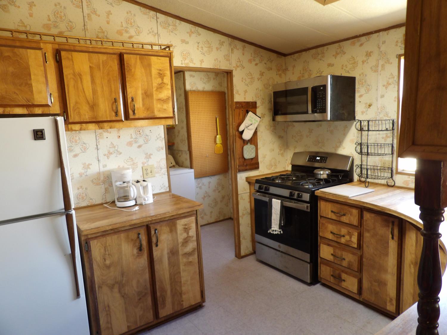 44001 Dunlap Road Miramonte, CA 93641 - Photo 57 of 91 a kitchen with stainless steel appliances granite countertop a stove a sink and a refrigerator