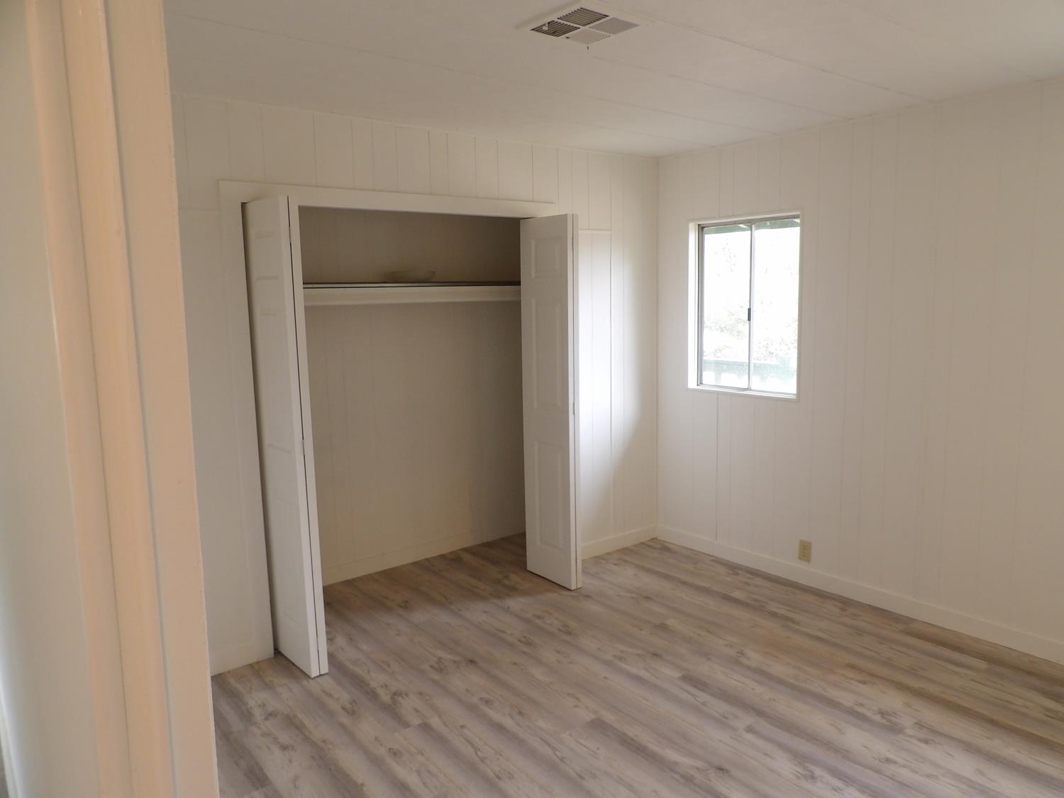 44001 Dunlap Road Miramonte, CA 93641 - Photo 76 of 91 an empty room with wooden floor and windows