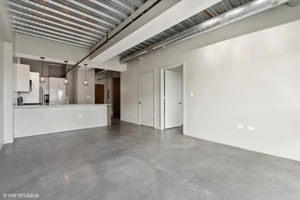 a view of a livingroom with a kitchen
