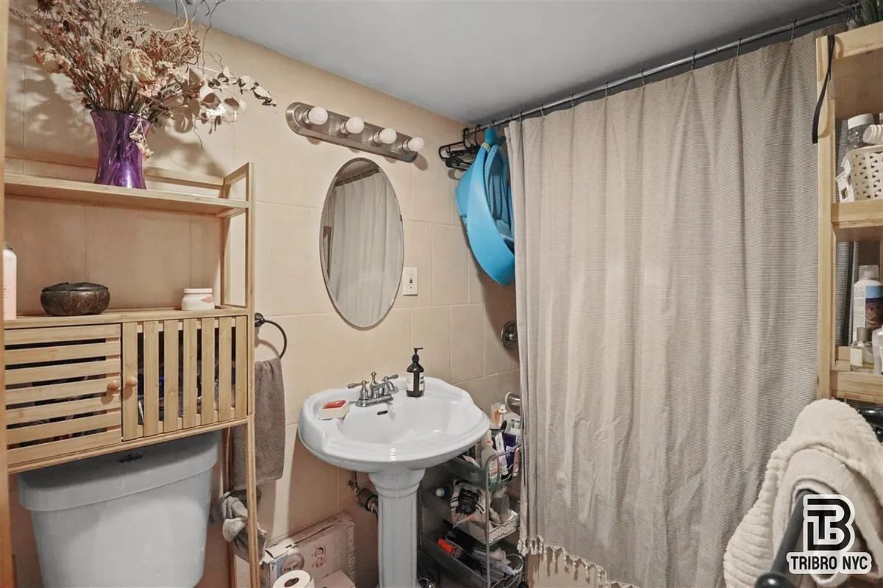 1309 Decatur Street, Unit 3C Brooklyn, NY 11207 - Photo 5 of 5 a bathroom with a sink a mirror and a shower curtain
