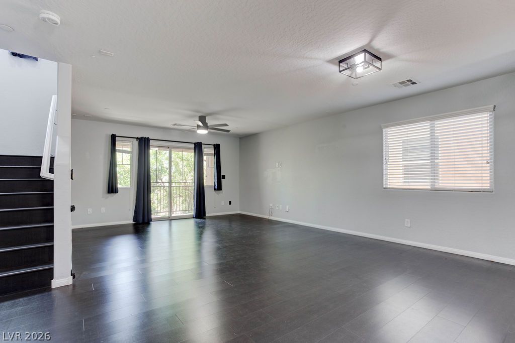 7724 Vibrant Thread Court Las Vegas, NV 89149 - Photo 15 of 43 A spacious living area with sleek dark wood flooring and ample natural light.