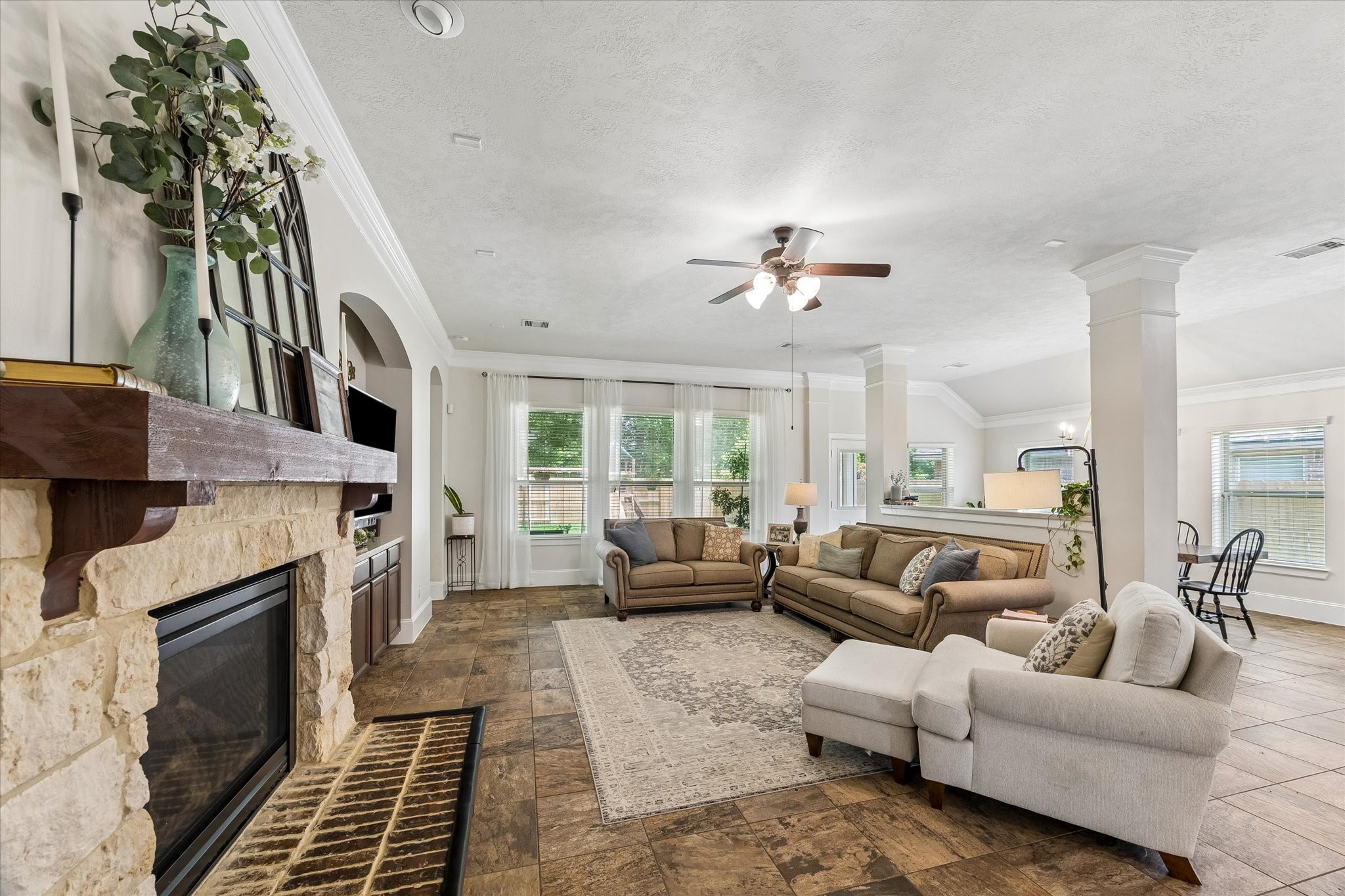 31306 Brighton Brook Lane Spring, TX 77386 - Photo 12 of 34 Spacious family room anchored by a stone fireplace and designed for comfortable gatherings.