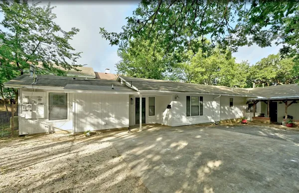 a front view of a house with yard patio and green space