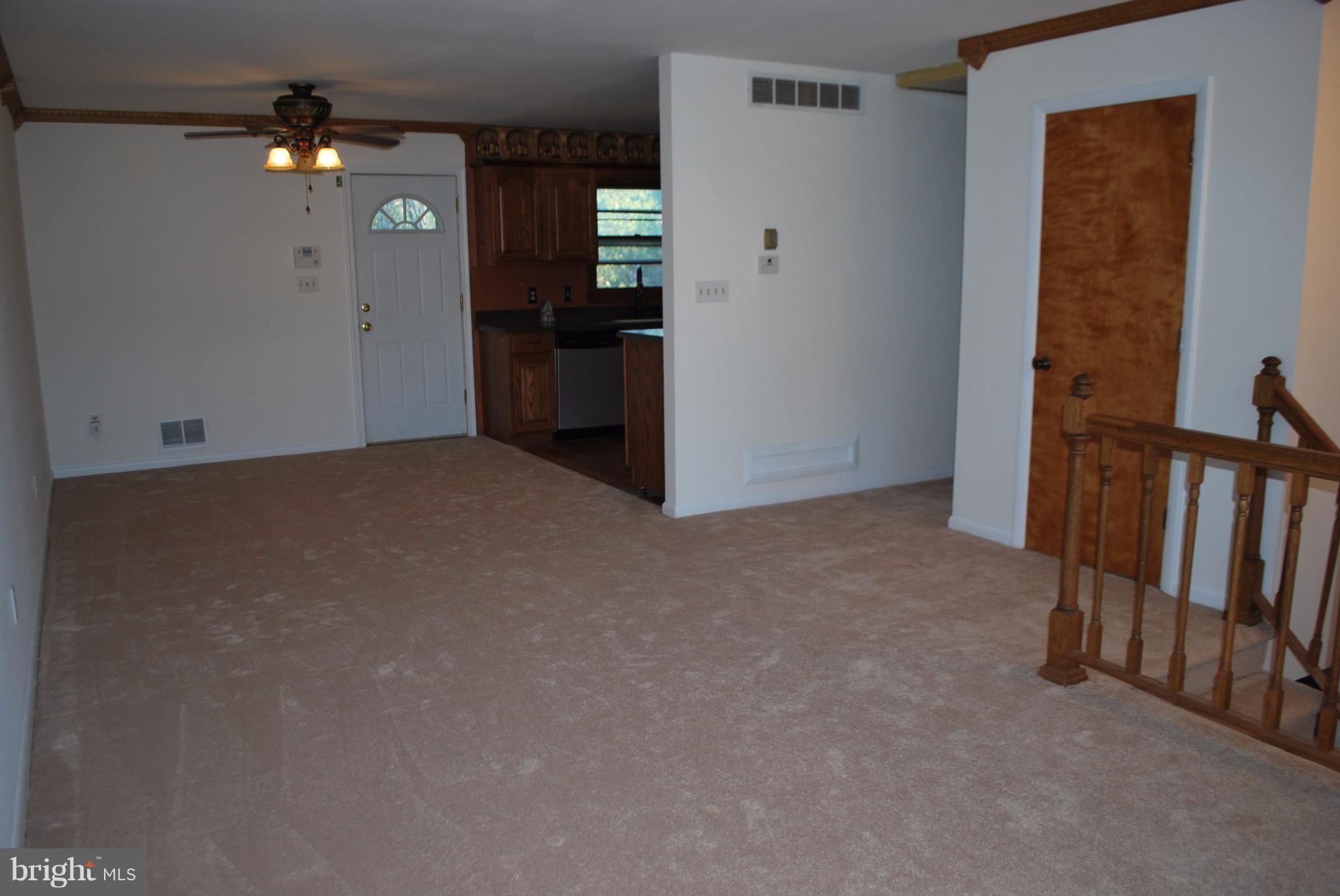 8263 Quarterfield Road Severn, MD 21144 - Photo 3 of 26 a view of an empty room with a kitchen