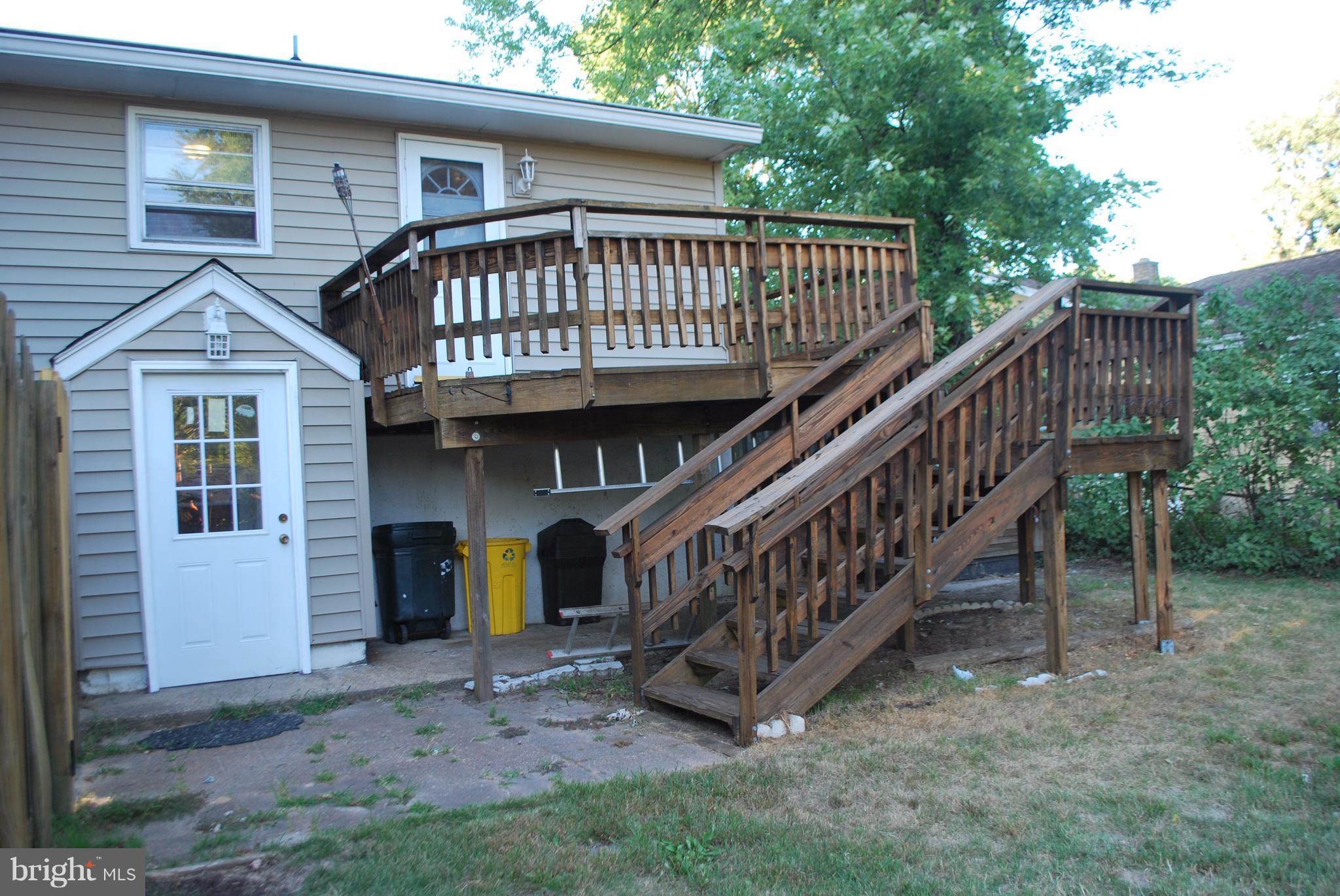 8263 Quarterfield Road Severn, MD 21144 - Photo 22 of 26 a view of a house with a yard and a deck