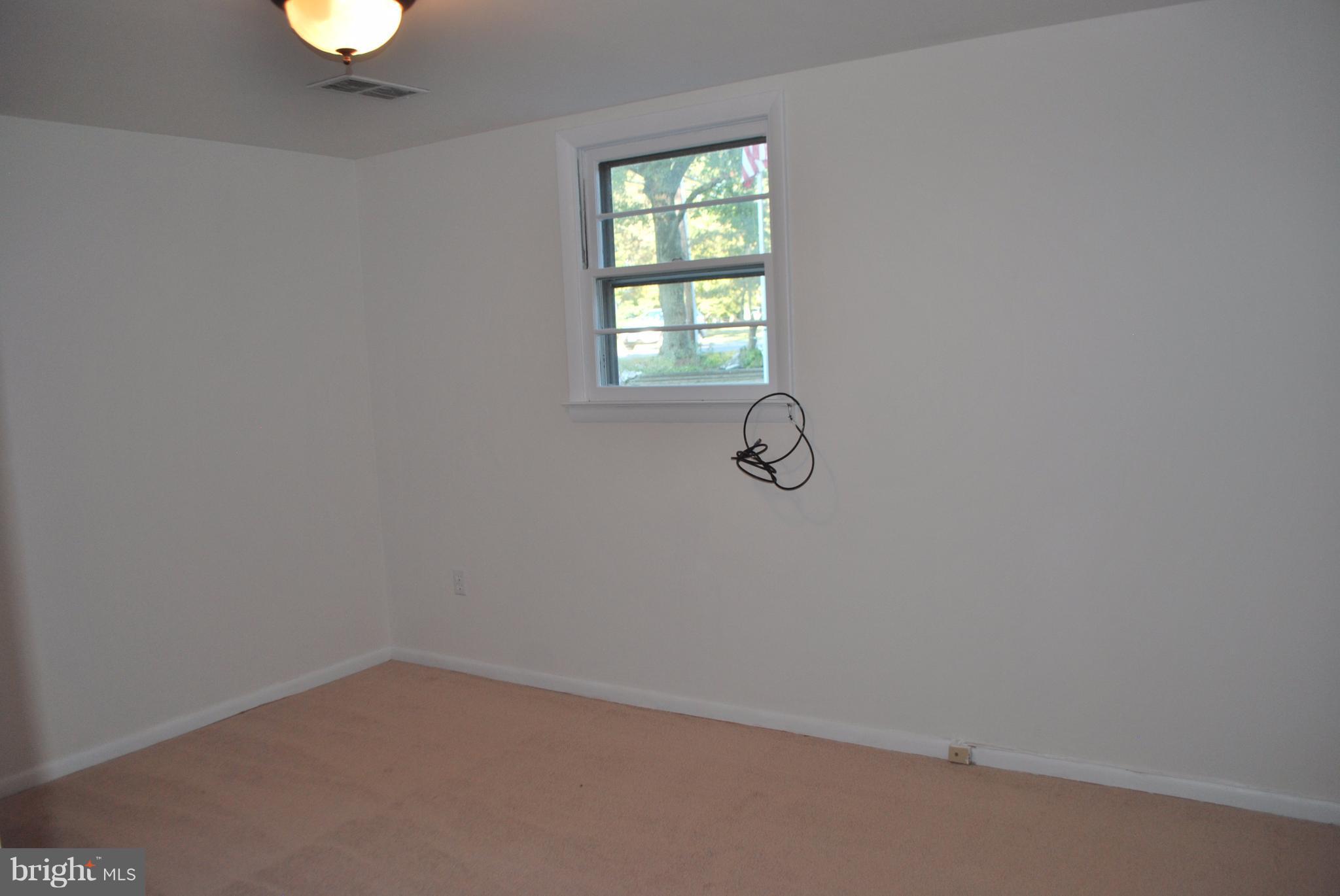 8263 Quarterfield Road Severn, MD 21144 - Photo 8 of 26 a view of a room with a window and a fan