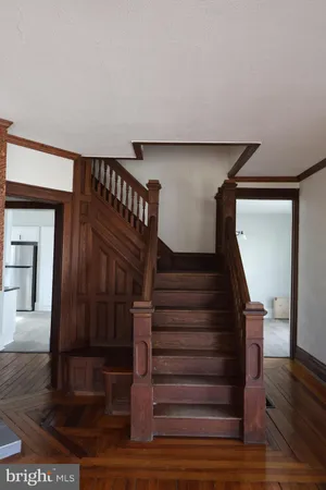 a view of entryway and hall with wooden floor