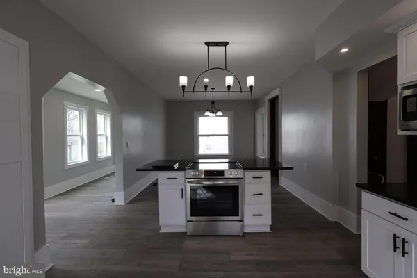 a view of an empty room with glass door and windows