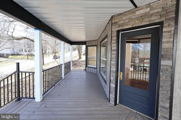 a view of a porch with wooden floor and stairs