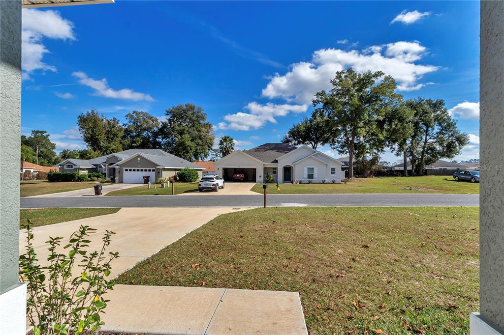 10090 Southeast 67th Terrace Belleview, FL 34420 - Photo 11 of 40 a view of a swimming pool and trees in the background