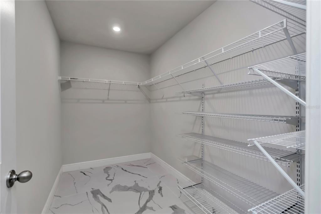 10090 Southeast 67th Terrace Belleview, FL 34420 - Photo 18 of 40 a view of a room with racks on the wall