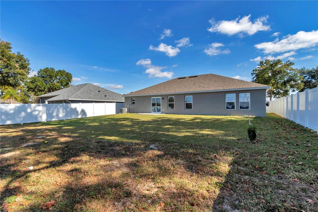 10090 Southeast 67th Terrace Belleview, FL 34420 - Photo 28 of 40 a front view of a house with garden