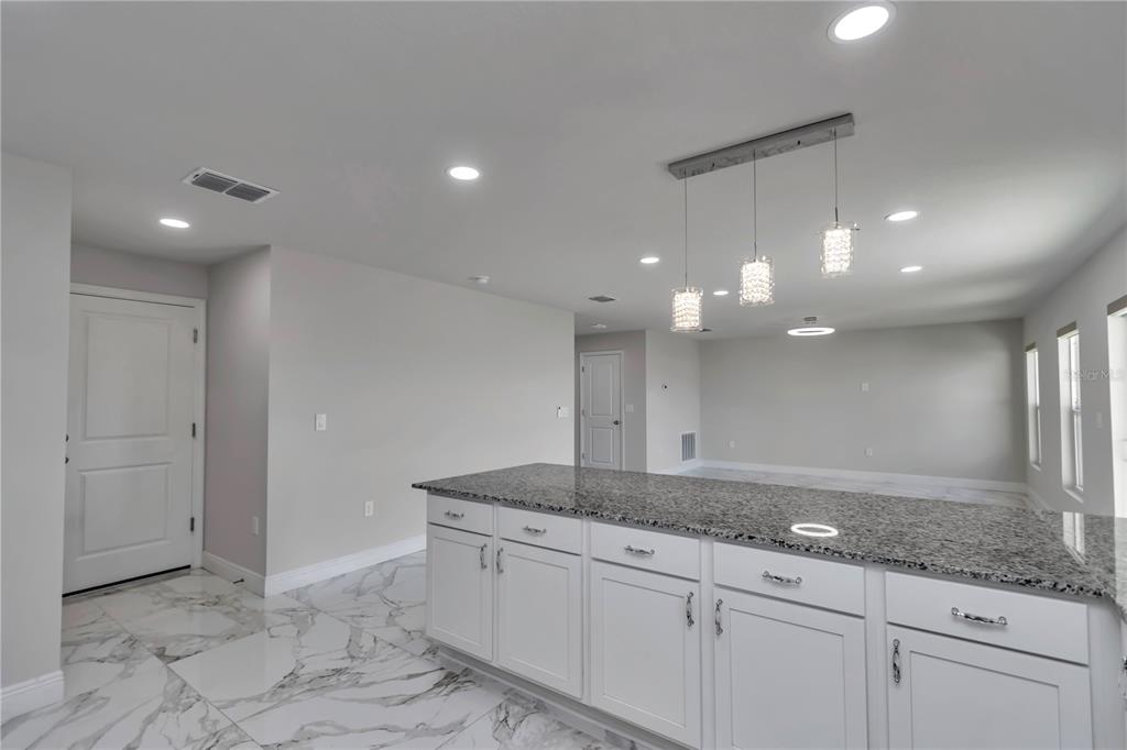 10090 Southeast 67th Terrace Belleview, FL 34420 - Photo 34 of 40 a bathroom with a granite countertop sink and a mirror