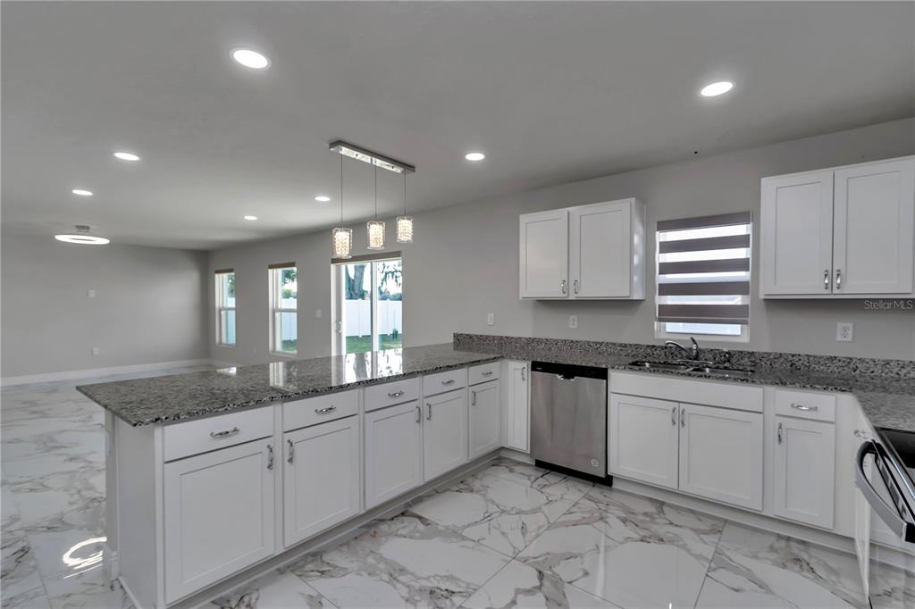 10090 Southeast 67th Terrace Belleview, FL 34420 - Photo 35 of 40 a kitchen with a sink and cabinets