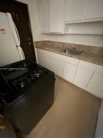 a kitchen with sink and cabinets
