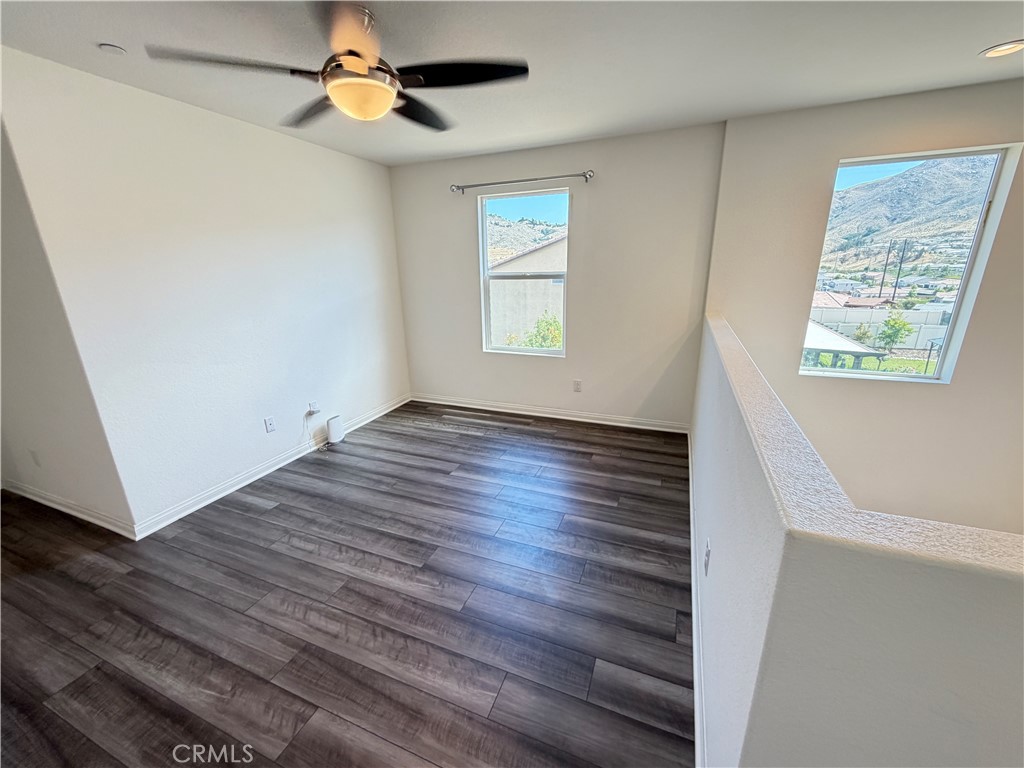 7483 Sage Scrub Road Riverside, CA 92507 - Photo 13 of 33 wooden floor in an empty room with a window