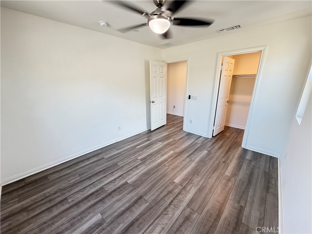 7483 Sage Scrub Road Riverside, CA 92507 - Photo 23 of 33 a view of a room with wooden floor and ceiling fan