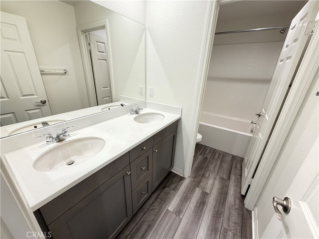 7483 Sage Scrub Road Riverside, CA 92507 - Photo 25 of 33 a bathroom with a double vanity sink and mirror