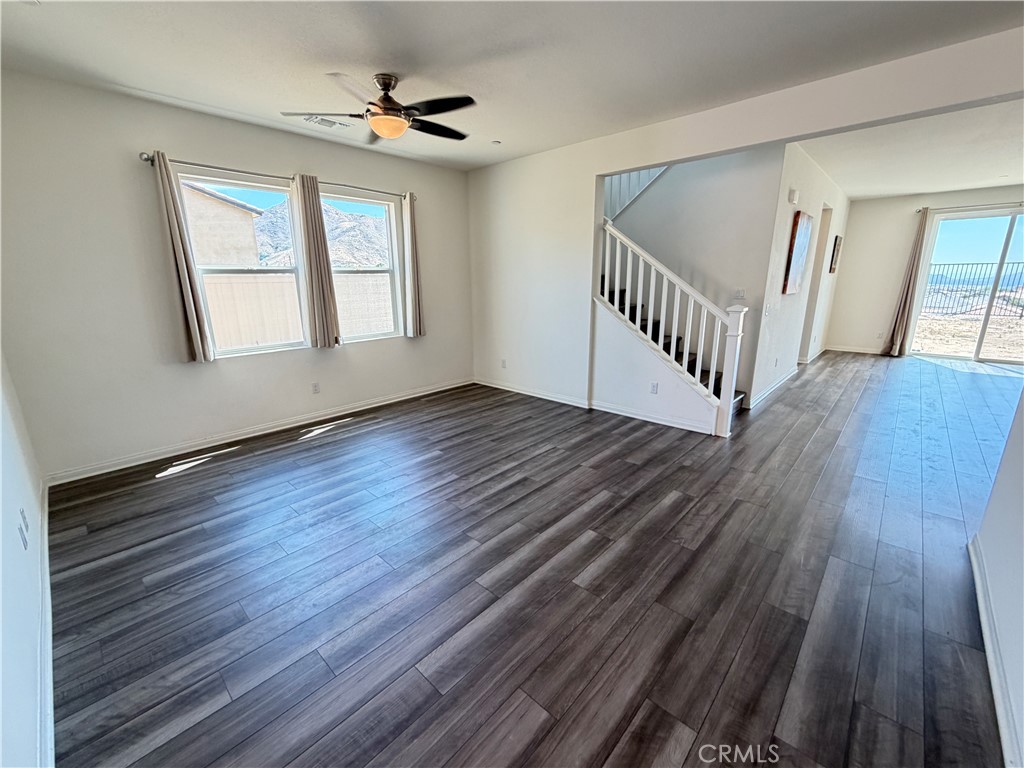 7483 Sage Scrub Road Riverside, CA 92507 - Photo 3 of 33 a view of an empty room with wooden floor and a window