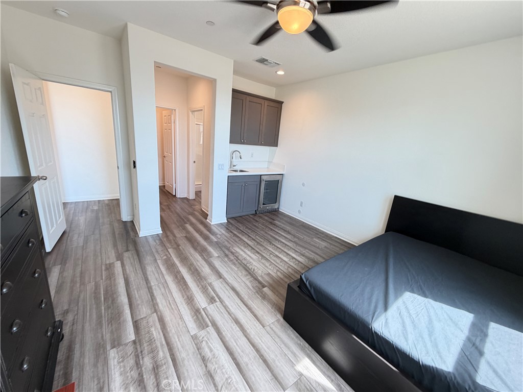 7483 Sage Scrub Road Riverside, CA 92507 - Photo 9 of 33 a view of a living room with furniture and wooden floor
