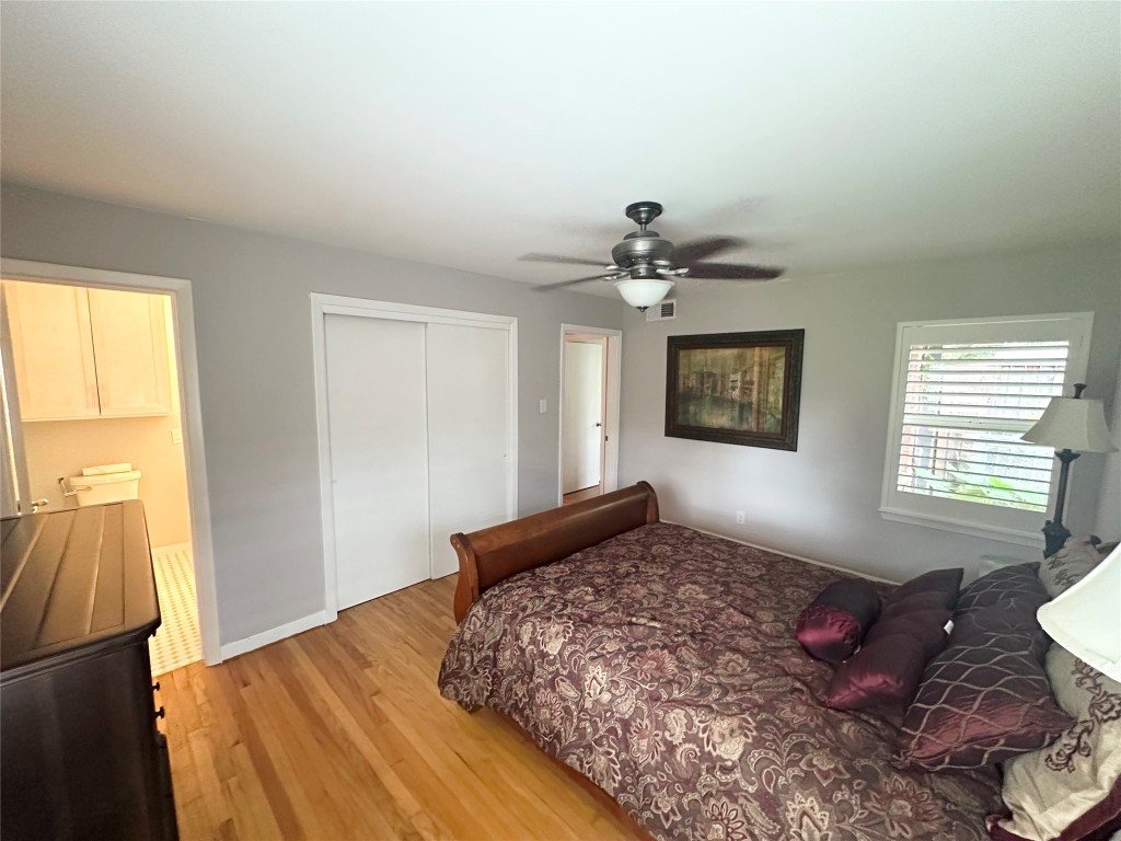 2123 Ridgecrest Drive Houston, TX 77055 - Photo 13 of 38 a bedroom with a bed and wooden floor