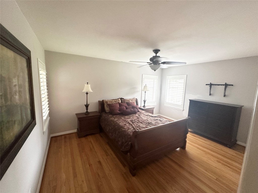 2123 Ridgecrest Drive Houston, TX 77055 - Photo 14 of 38 a spacious bedroom with a bed and a chandelier