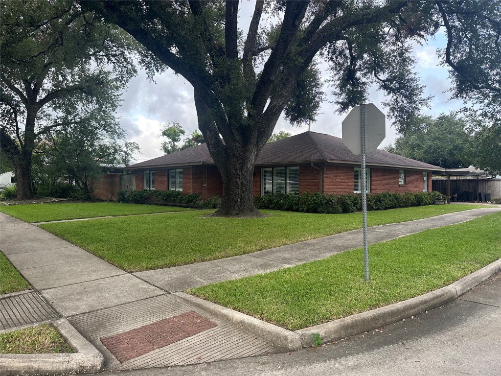 2123 Ridgecrest Drive Houston, TX 77055 - Photo 2 of 38 a view of a house next to a big yard and large trees