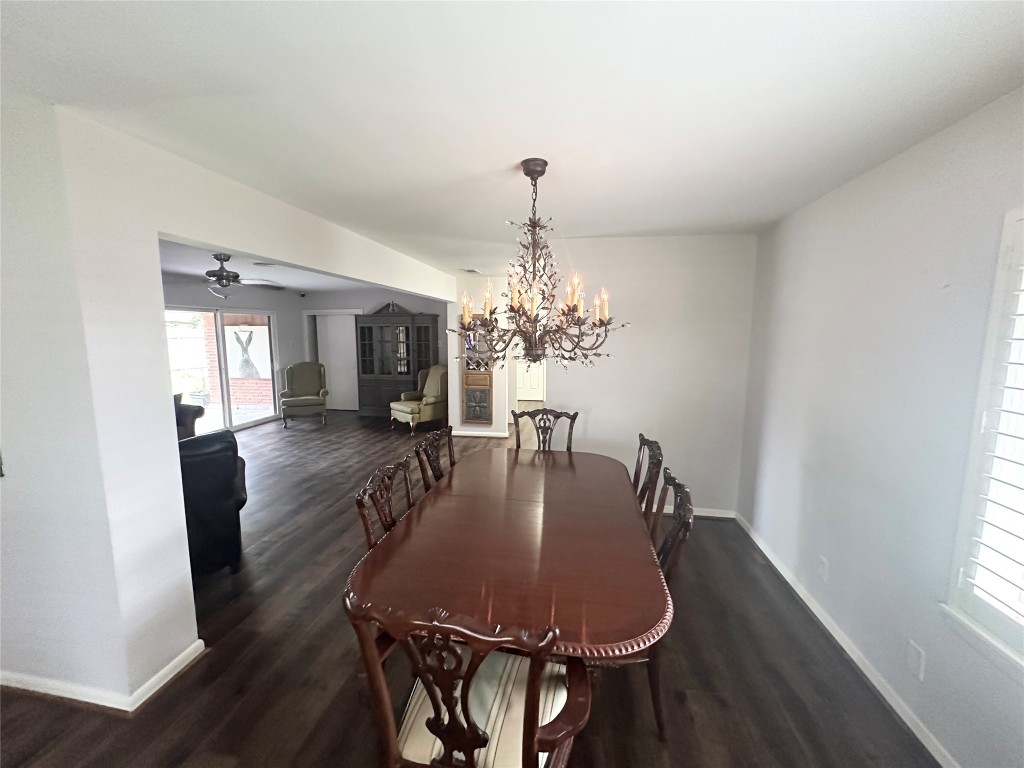 2123 Ridgecrest Drive Houston, TX 77055 - Photo 33 of 38 a dining room with furniture a chandelier and wooden floor